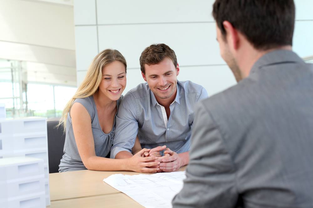 Couple meeting with banker regarding Brisbane investment property
