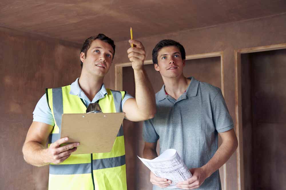 Building Inspector Working WIth Buyers to Secure A Good Investment